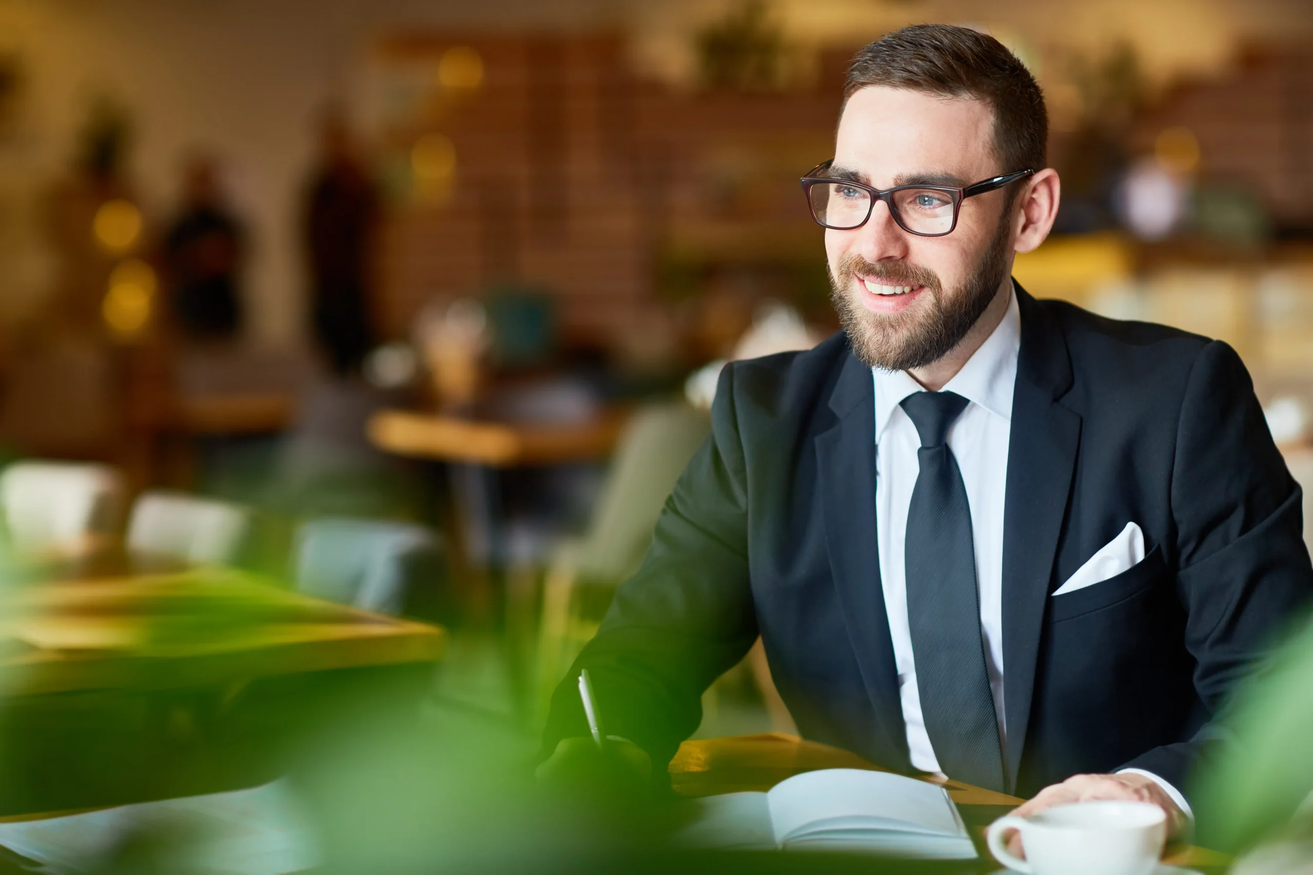 Professional lawyer in a suit working at a desk, representing modern law firm photography